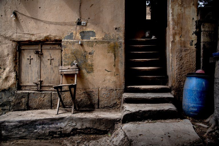 Chair on a wall in the Coptic cemetery in Cairo, somewhat rotten but romantic with a stairway